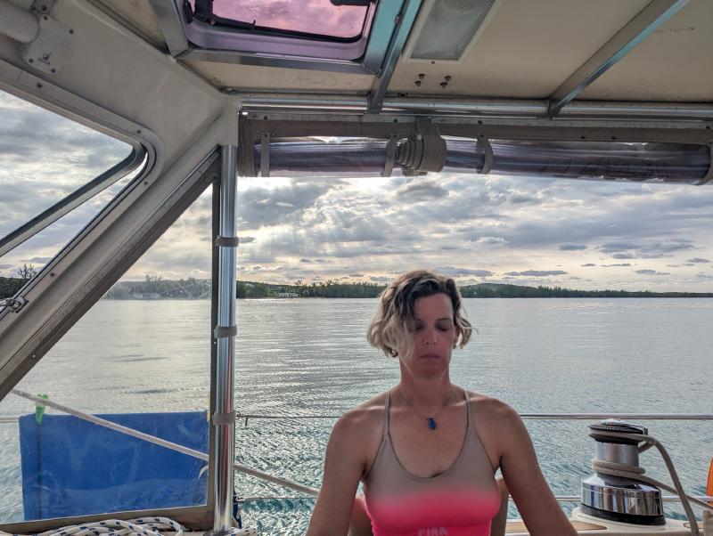 A photo Charlie took of me while meditating in the cockpit with a slightly overcast moody sky with the sun behind it, somewhere in the Bahamas, 2024